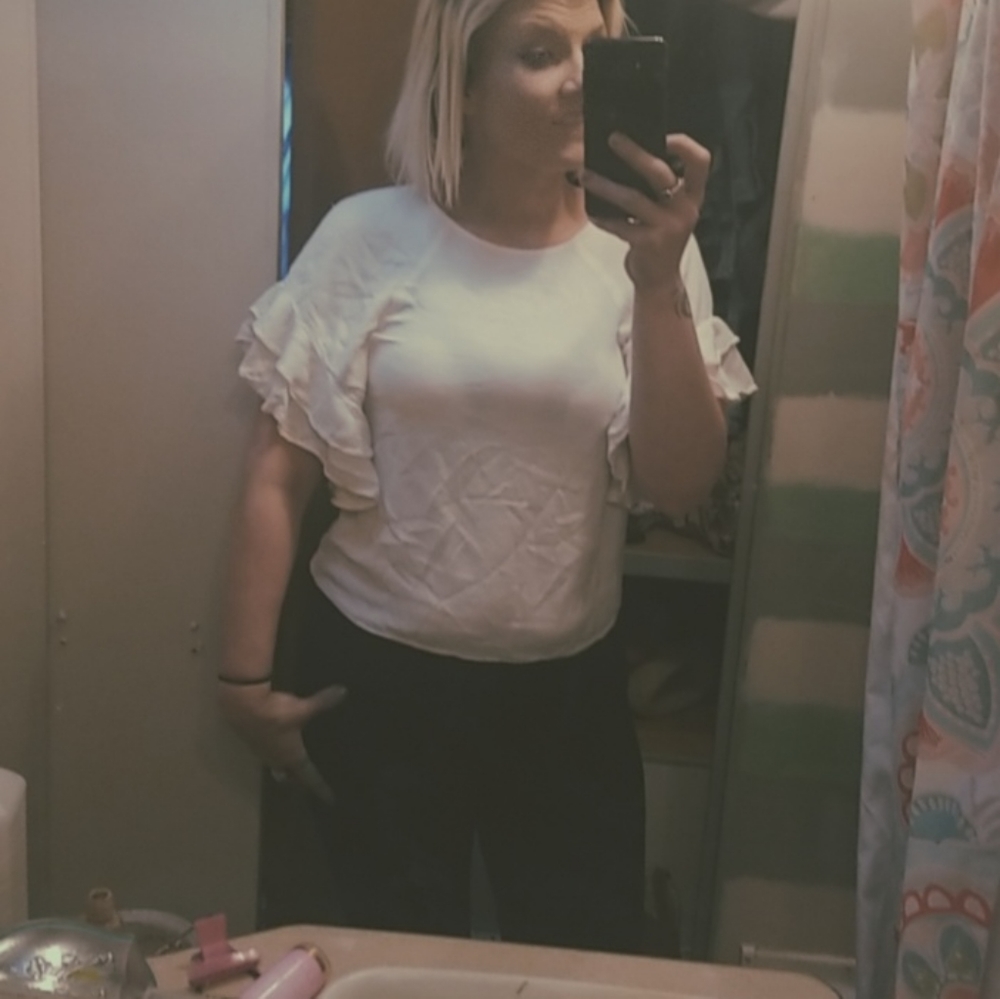 White ruffled sleeve blouse.